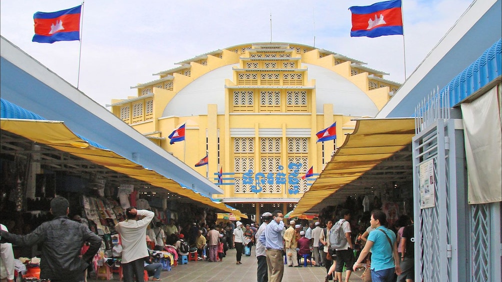 People walking through a bustling market in Phnom Penh