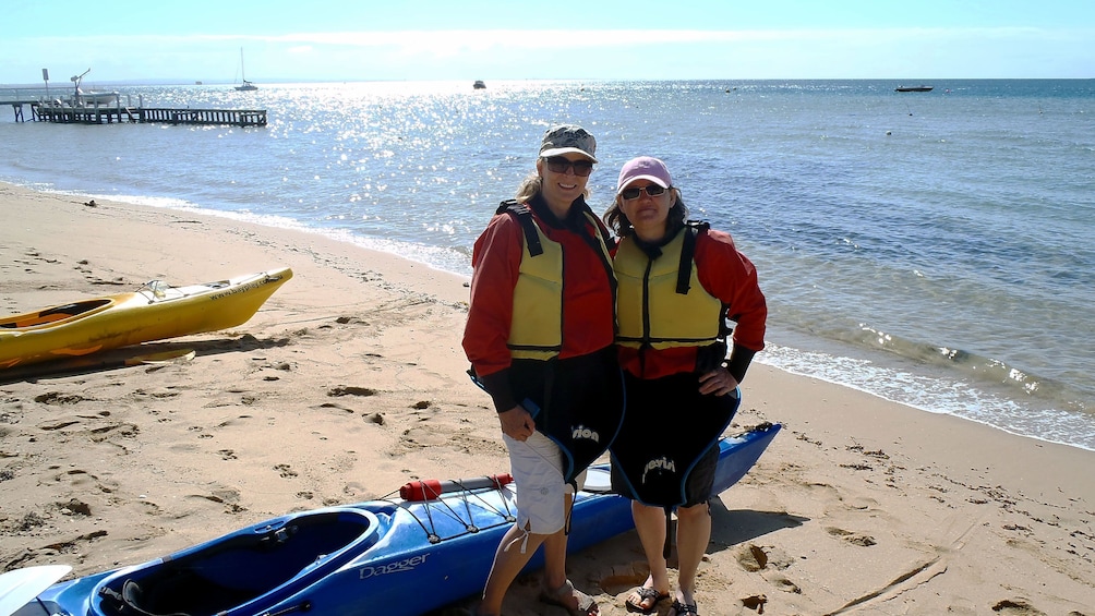 Two women with their Kayak on a beach at Mornington Peninsula