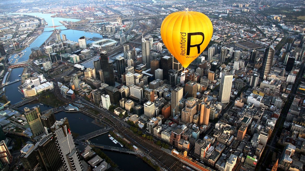 Hot air balloon flying over the skyscrapers of Melbournes