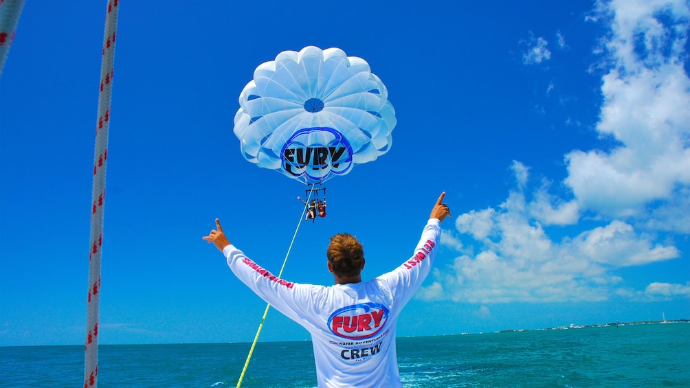Crew member guiding mother and daughter parasailing in Key West