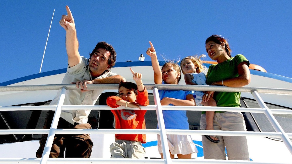 Family navigating the sea on the glass bottom boat in Key West