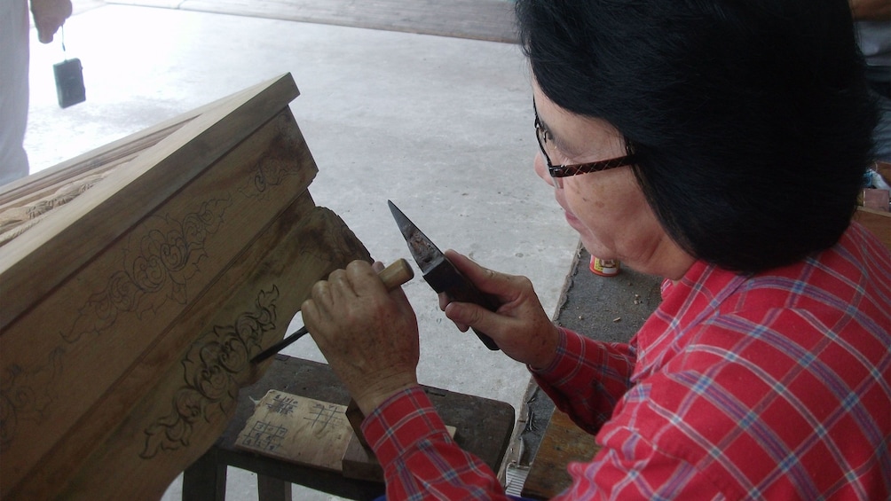 Man working on wood carving in Chiang Mai