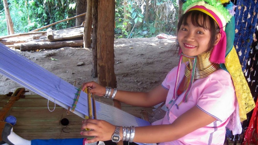 Woman working on weaving loom in chiang rai