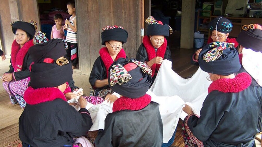 People wearing black and red outfits in chiang rai