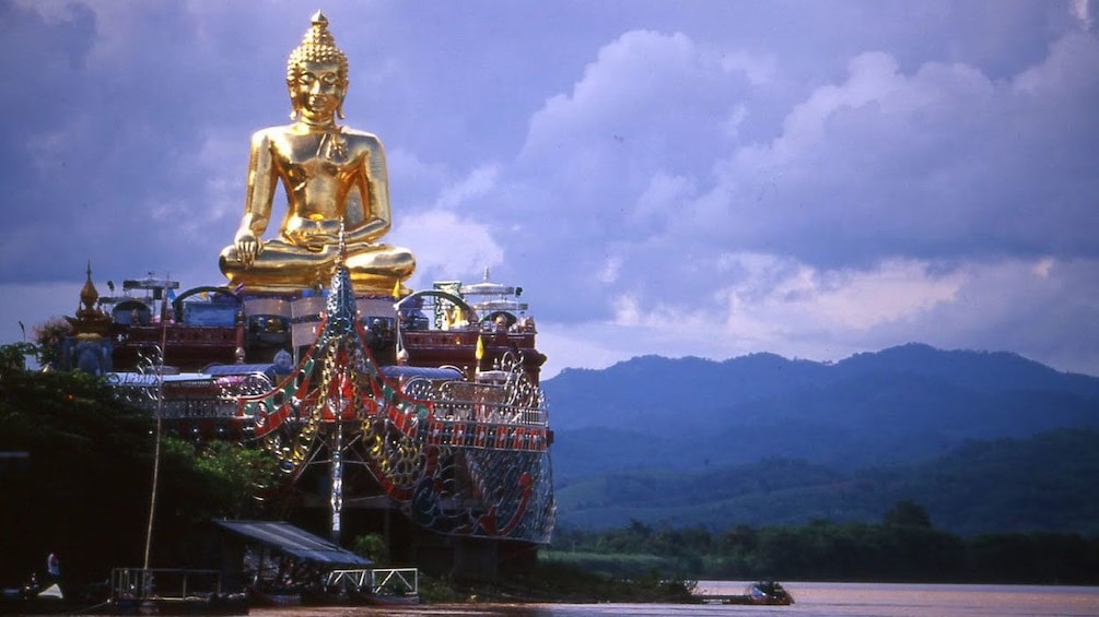 Golden statue near coast in Chiang Rai