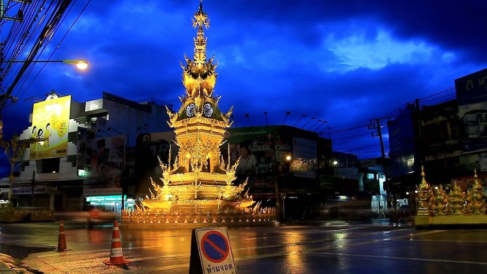 Illuminated golden statue in Chiang Rai