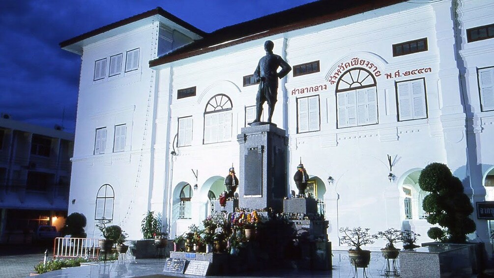 Statue in front of white building in Chiang Mai