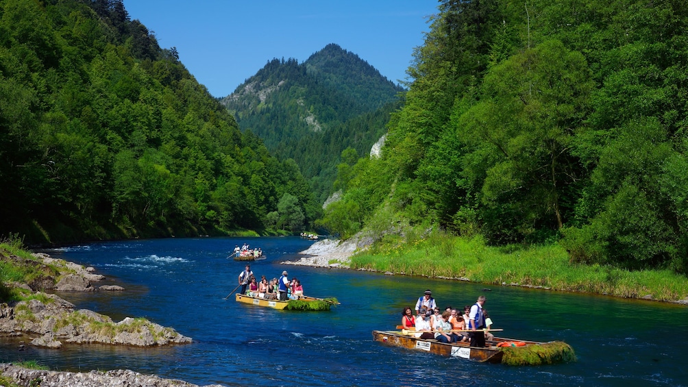 Guests enjoying a wooden raft trip down the Dunajec River in Poland 