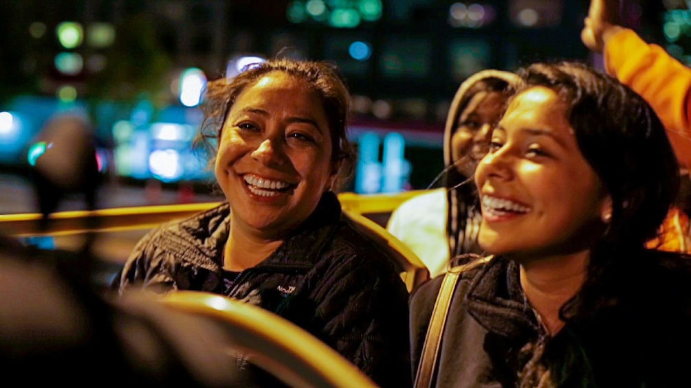 Smiling women on sightseeing bus in San Francisco