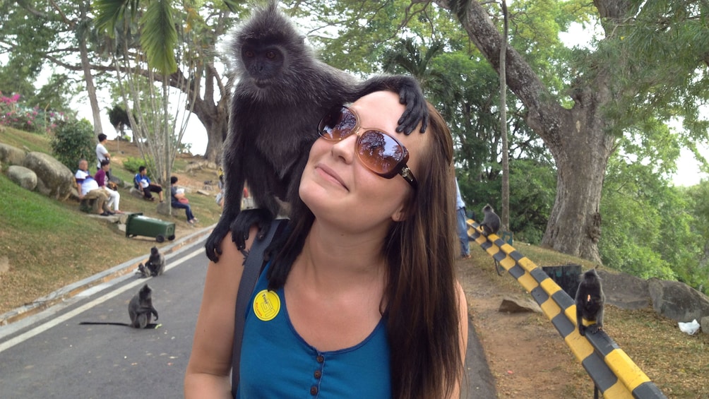 woman with a monkey in kuala lumpur