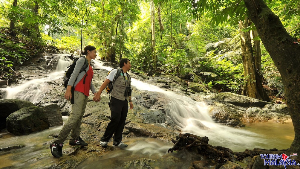 people hiking near stream in kuala lumpur