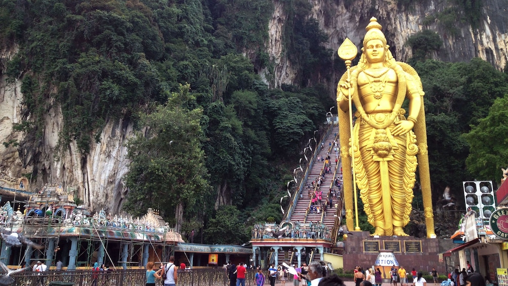 Large golden statue at the entrance of Batu Caves