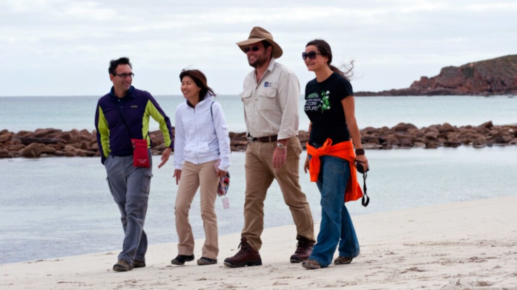 A group of people walking along the shore on Kangaroo Island