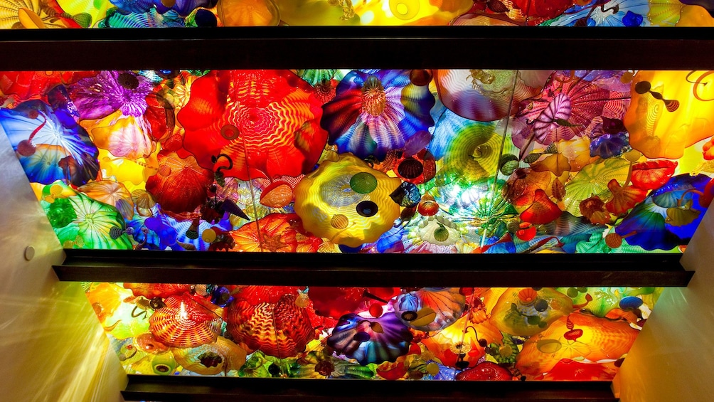 Ceiling top full of colorful glass sculpture of different shapes sizes and colors at the Chihuly Garden and Glass in Seattle 