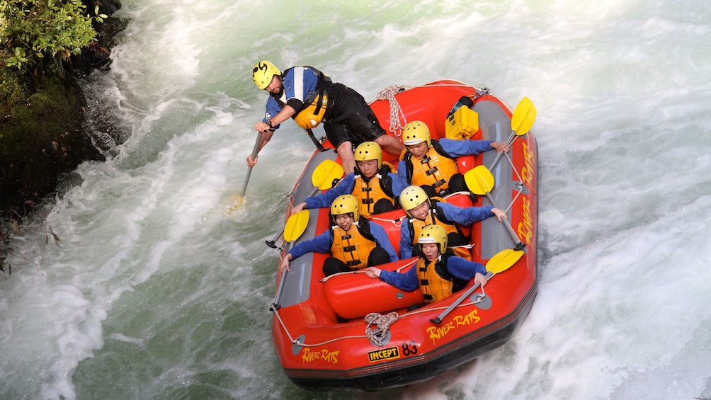 Show item 4 of 5. white water rafters hanging on while guide paddles in New Zealand