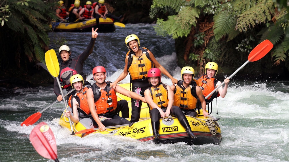 Show item 3 of 5. white water rafters feeling accomplished in New Zealand