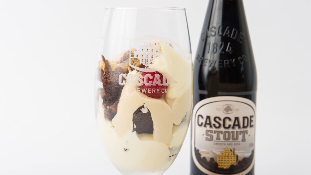 Close view of a bottle of the Cascade Stout and dessert glass at the Cascade Brewery Heritage Tour in Tasmania Australia 