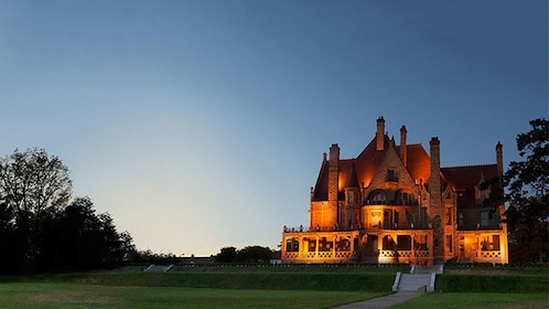 Show item 1 of 6. Craigdarroch Castle illuminated as the sun goes down in Victoria