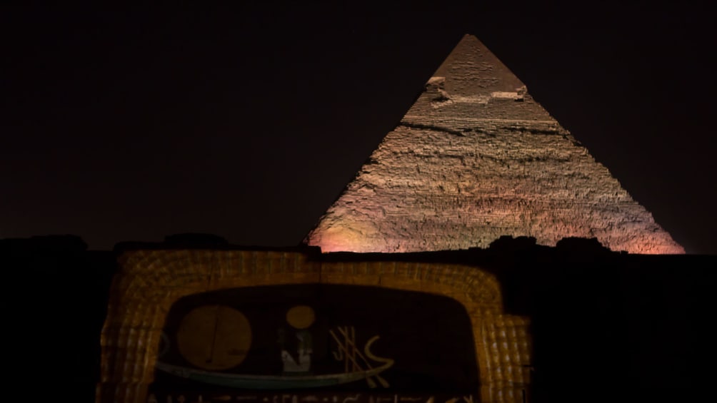 Foto 3 van 6. A pyramid lit at night in Giza