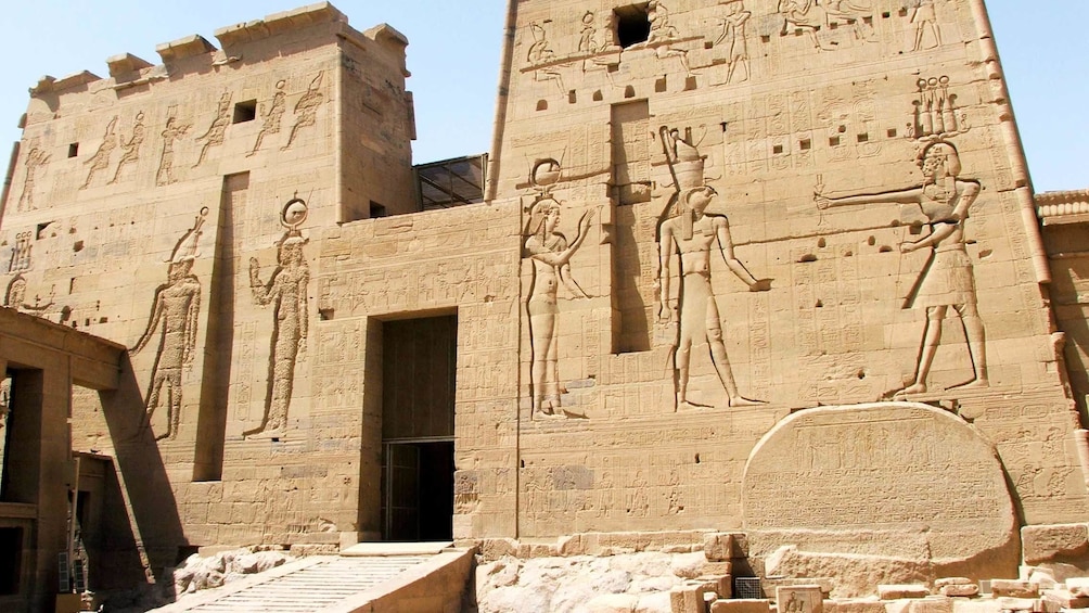 Ancient carvings decorate the outer wall of the Philae Temple