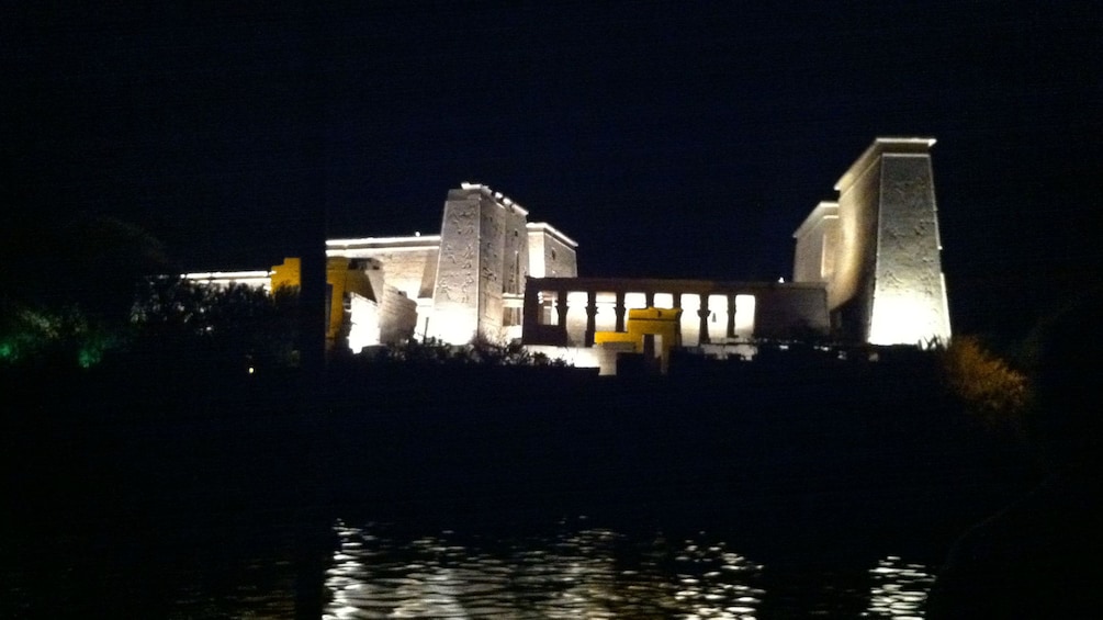 Philae Temple lit up at night and reflected in the reservoir in Aswan