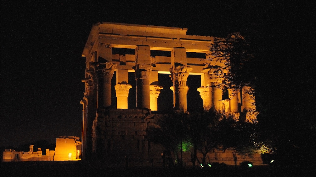 Trajan's Kiosk lit up at night on the island of Philae in Aswan 