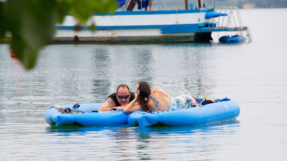 couple relaxing on a floating raft in Phuket