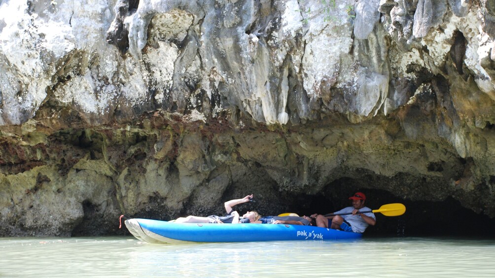 kayaking through a low hanging cave in Phuket