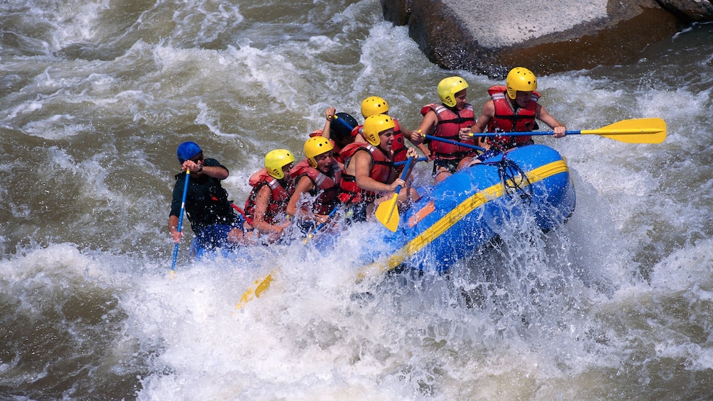 whitewater rafters fighting strong rapids in Phuket