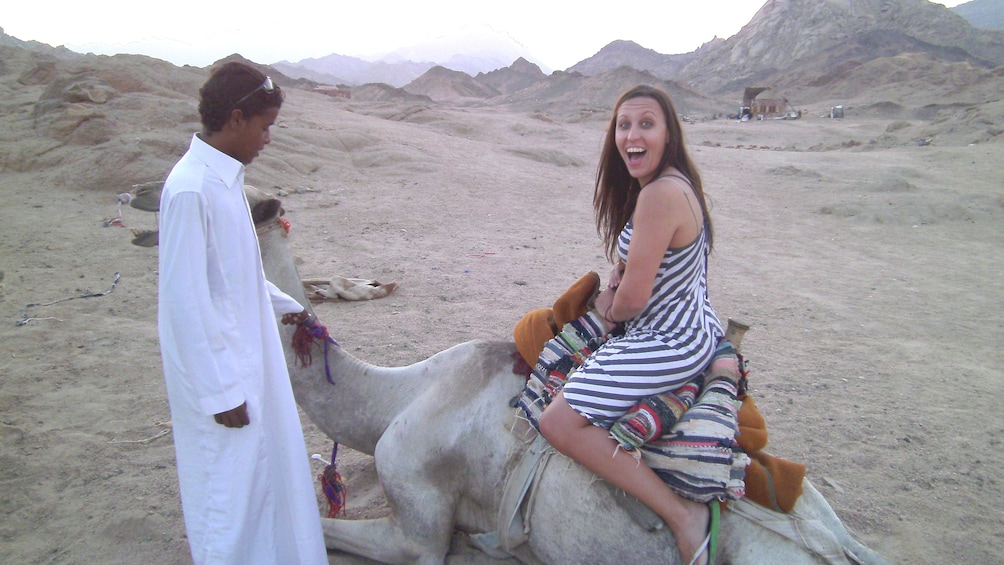 woman riding camel in egypt