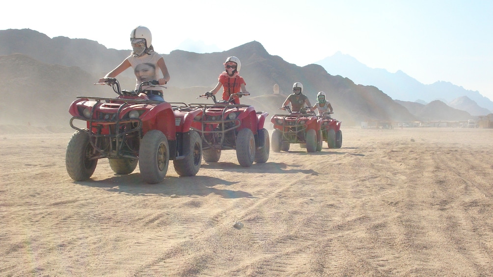 quad bikers ride in a single file line in Sharm el Sheikh