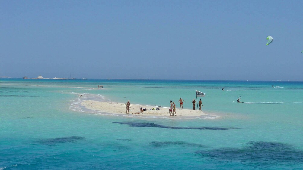 A small group of people on a sand bar in Mahmaya