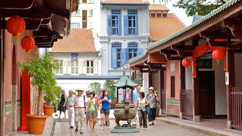 Group walking down the street with Chinese architecture in china town in Singapore