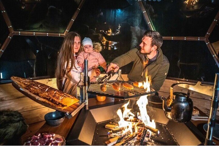 Glass Igloo Dinner on the shore of frozen Lake