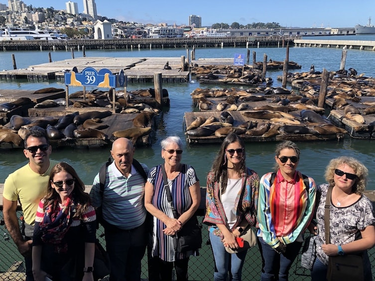 Tour group poses with seals on docks at Fisherman's Wharf