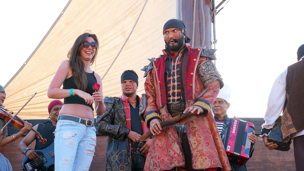 Woman on stage with pirates during Sunset Cruise in Puerto Vallarta