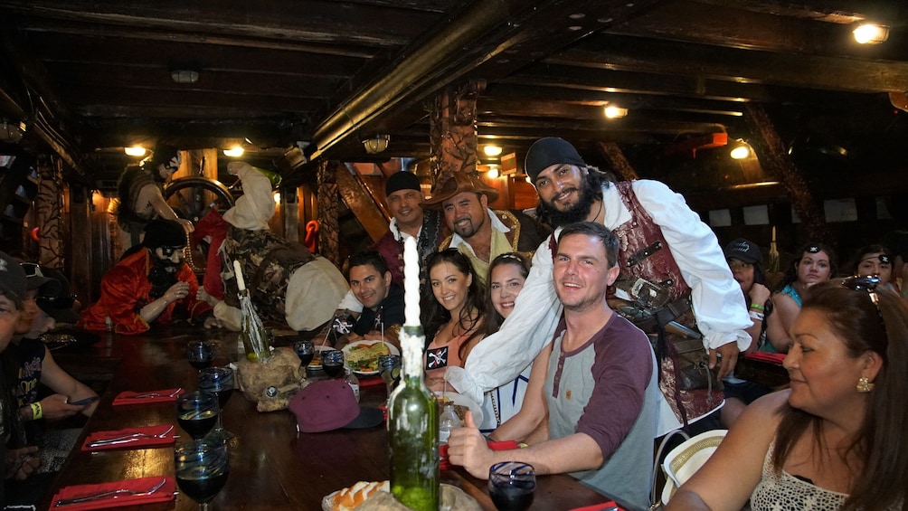 Three pirates pose with cruise guests in Puerto Vallarta