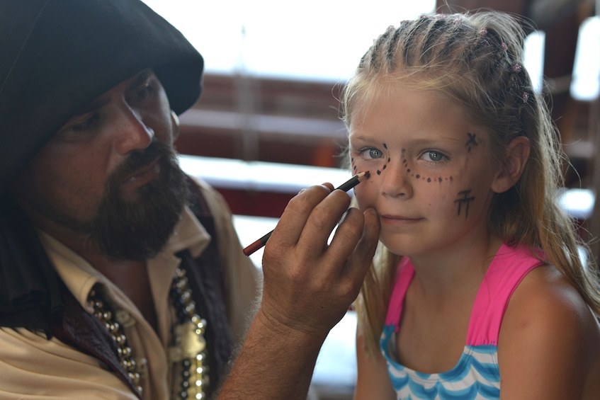 Child gets face painted by pirate in Puerto Vallarta