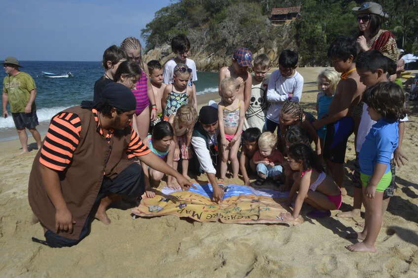 Children and a pirate look at a treasure map in Puerto Vallarta