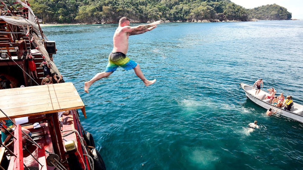 Man jumping from pirate ship into water in Puerto Vallarta