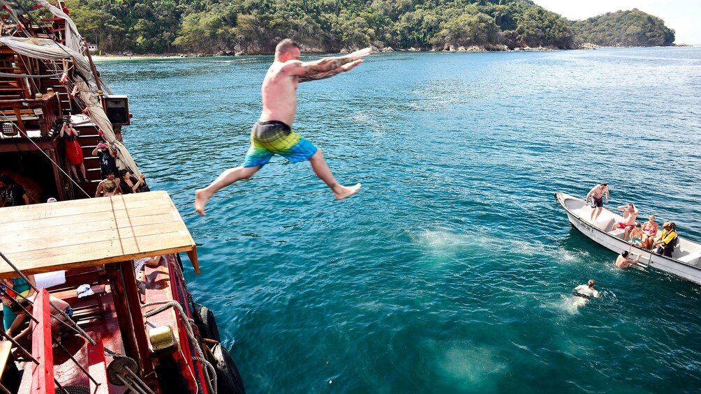 Man jumping from pirate ship into water in Puerto Vallarta