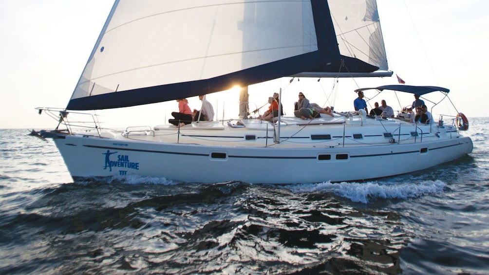 Guests enjoy the sunset over Banderas Bay from onboard a luxury sailboat