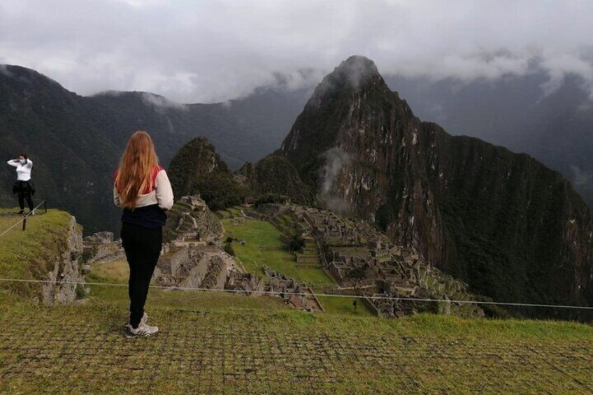 Machupicchu Center customer from Germany taking picture at Machu Picchu during guided tour at sunrise