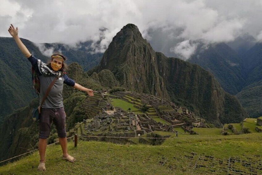 Machupicchu Center customer from Canada taking picture at Machupicchu at Sunrise during guided tour