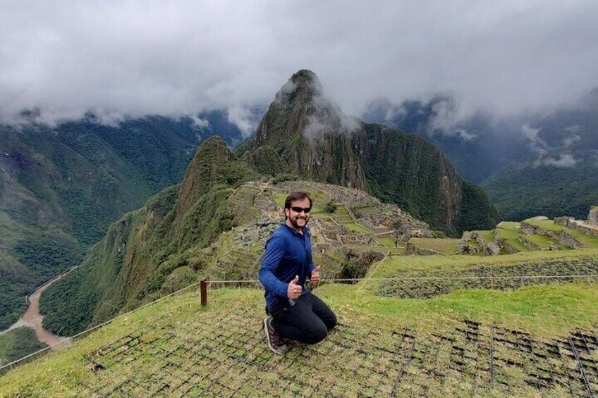 Machupicchu Center customer from USA taking picture at Machu Picchu during guided tour