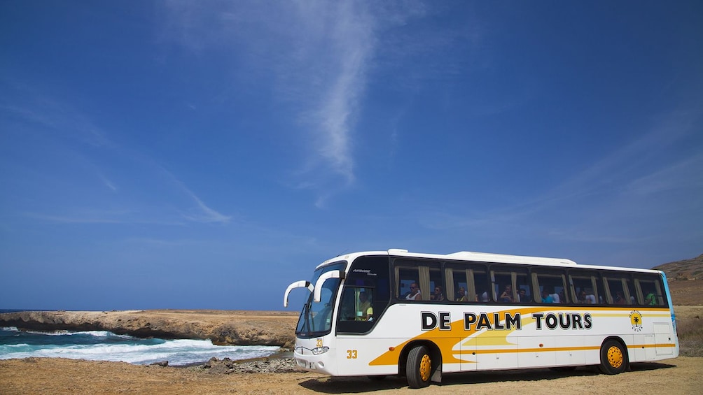 Tour bus parked near the shore in Aruba