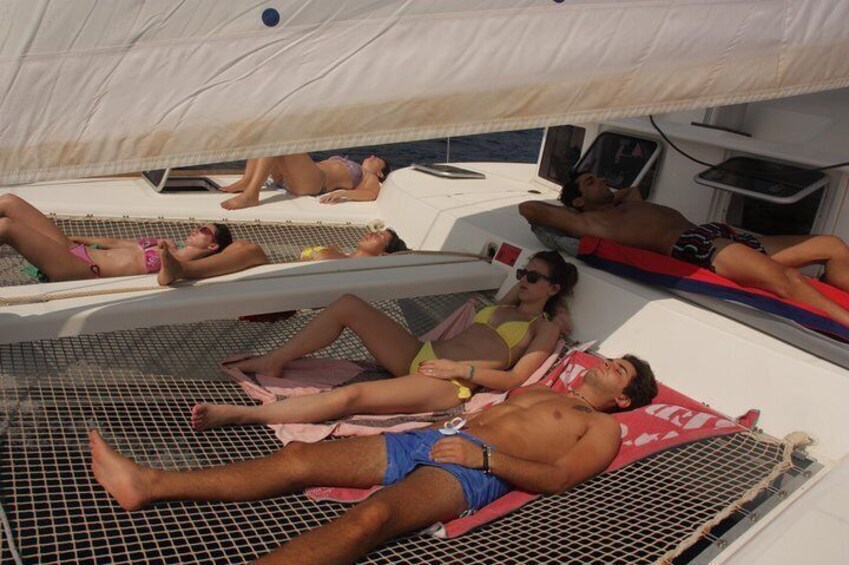 The nets on our catamaran are the perfect place to relax and sunbathe.