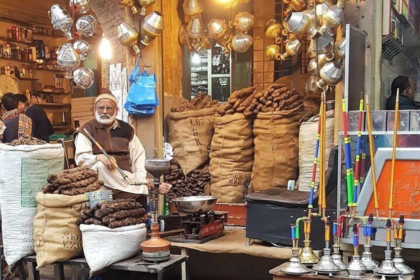 A vendor in streets of walled city Lahore selling Vape.