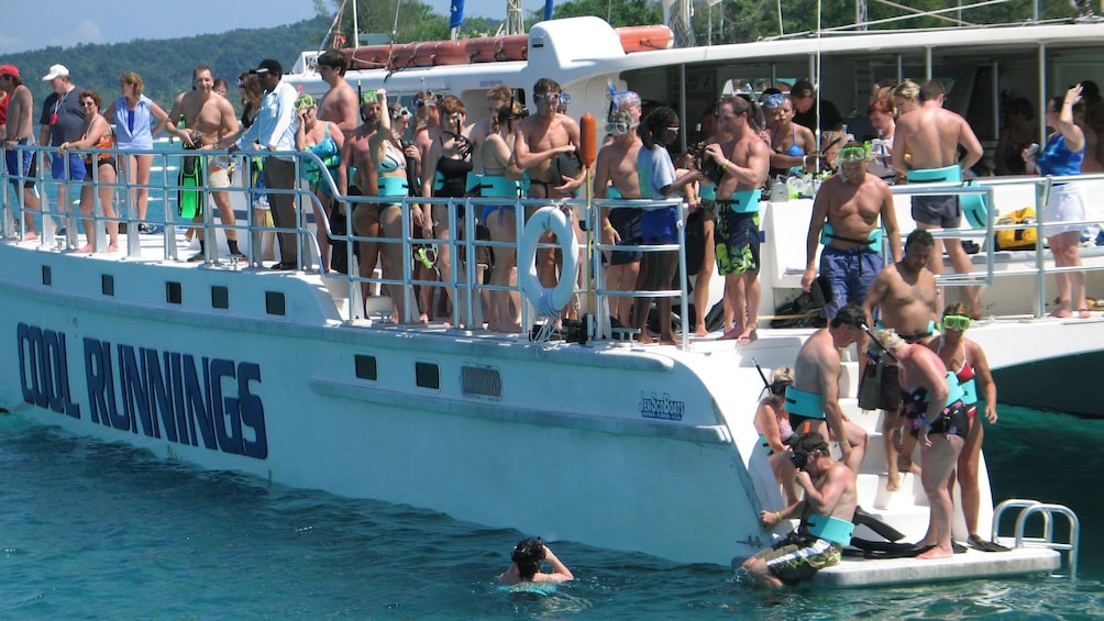 People getting off the boat to go snorkeling in the Caribbean sea near Jamaica 