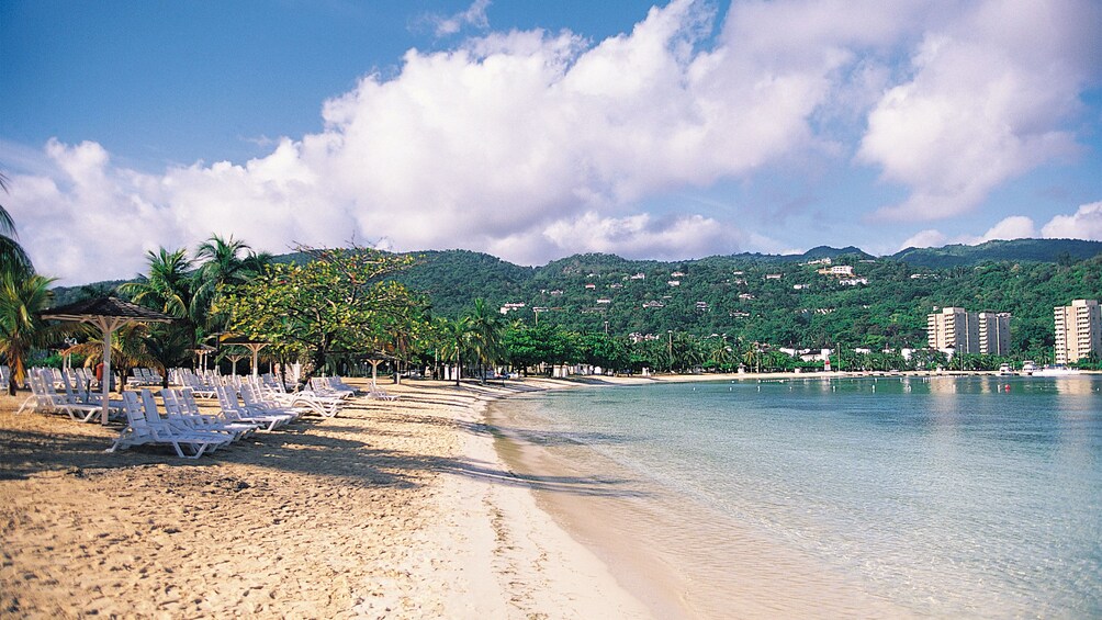 sandy beach with chairs in jamaica